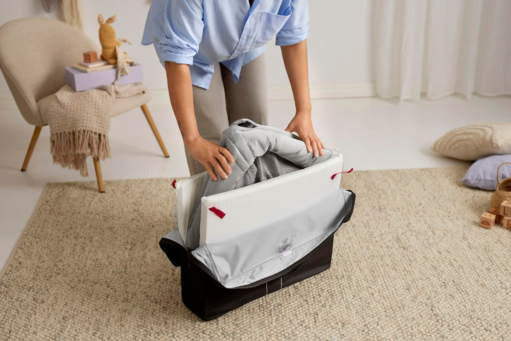 BabyBjorn Travel Crib Light silver fitted sheet included for quick setup.