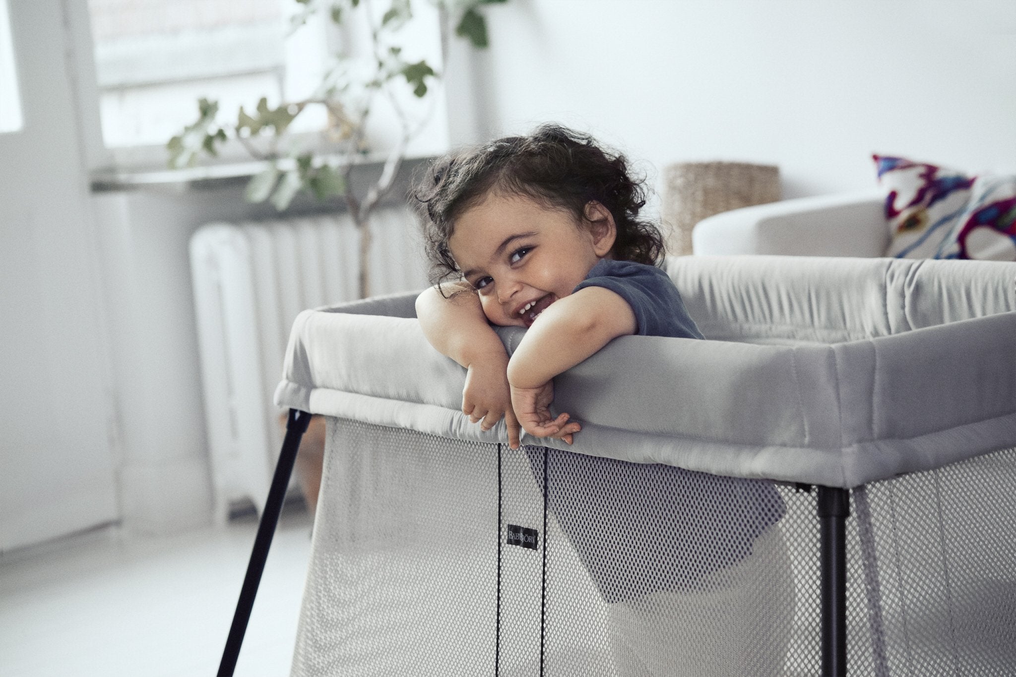 BabyBjorn Travel Crib Light silver mattress provides soft, comfy sleep for baby.