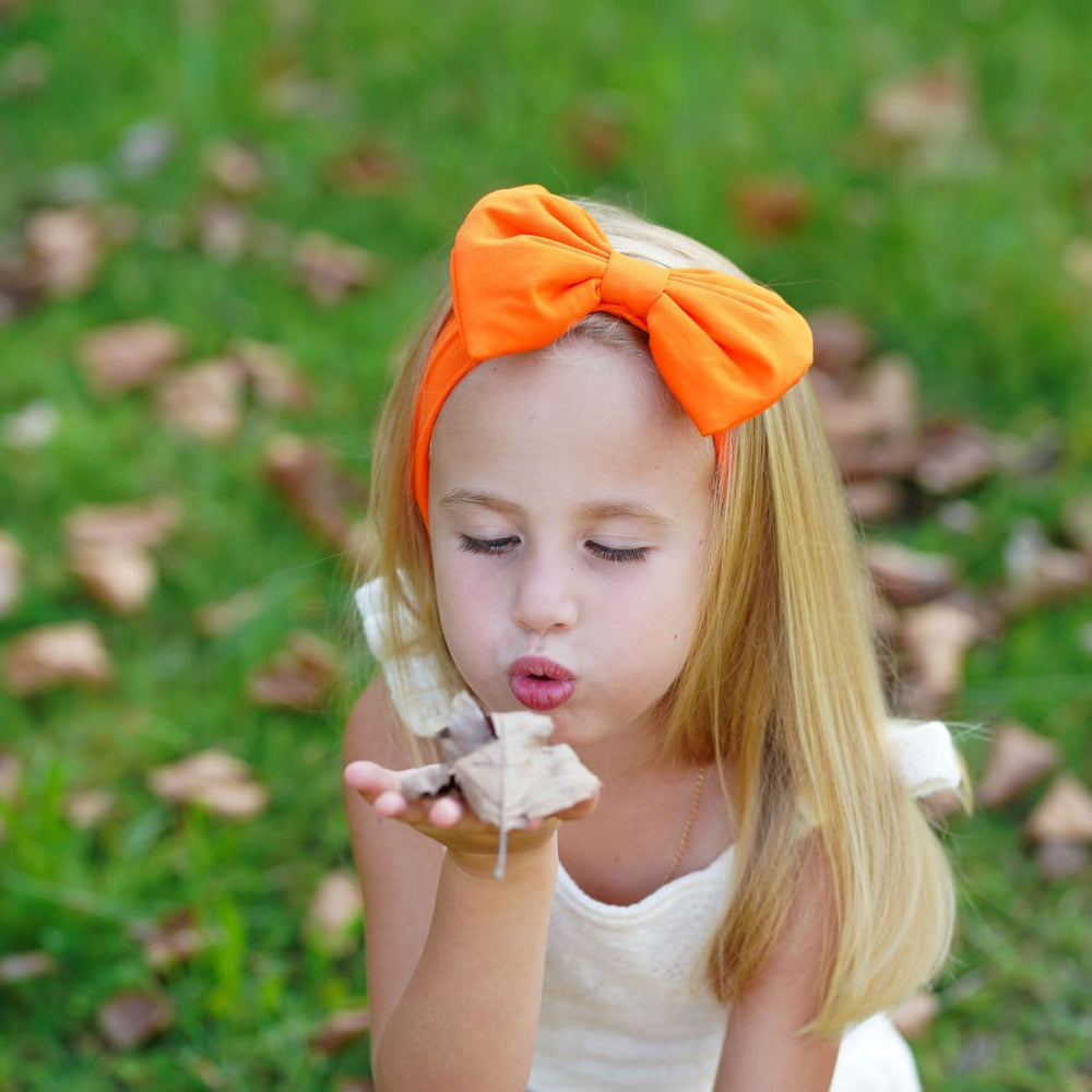 BABYGIZ orange bow headband as a cute photo prop for infants.