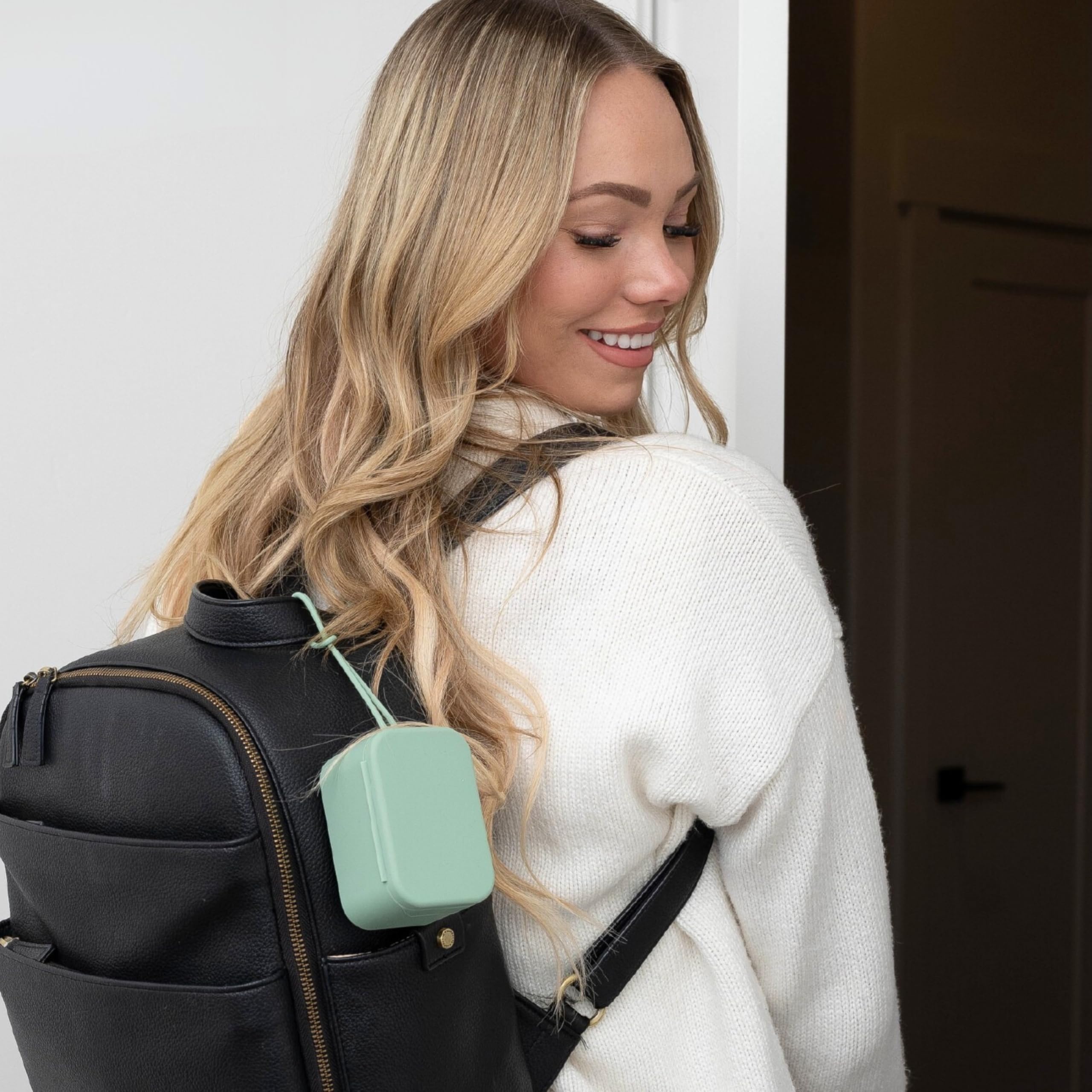 Locking strap secures to bags, strollers, or cribs for convenience.