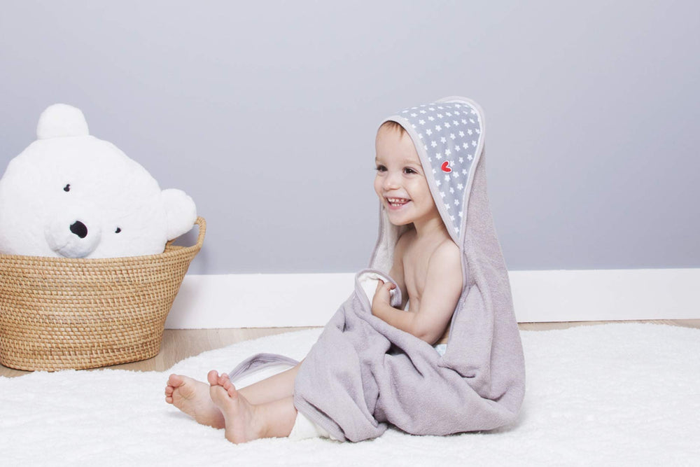 BabyToLove white stars print towel offers cozy, playful design for newborns.