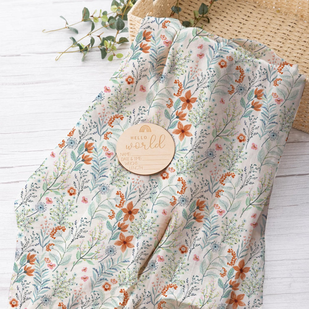 BabyWhale newborn blanket shown with birth announcement card as keepsake