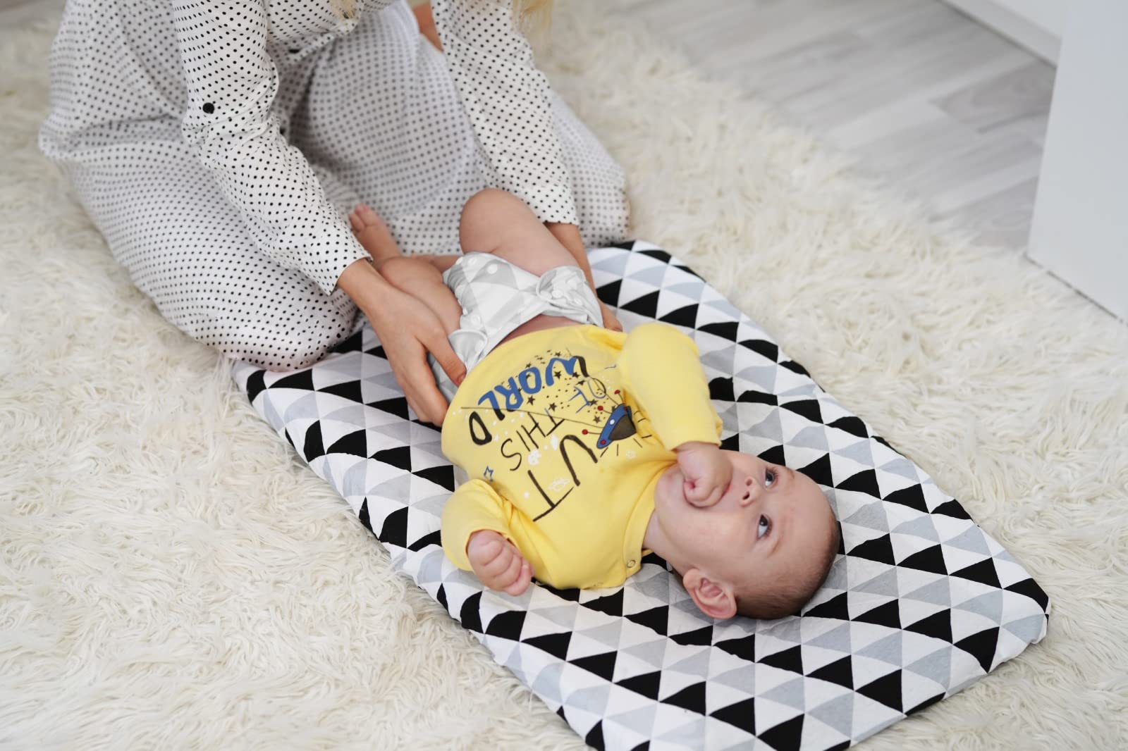 BaeBae Goods changing pad cover elastic edge for secure fit on mat.