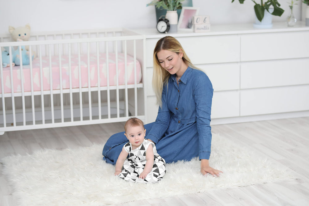 BaeBae Goods sleeping bag unisex triangles image emphasizes versatile nursery style.