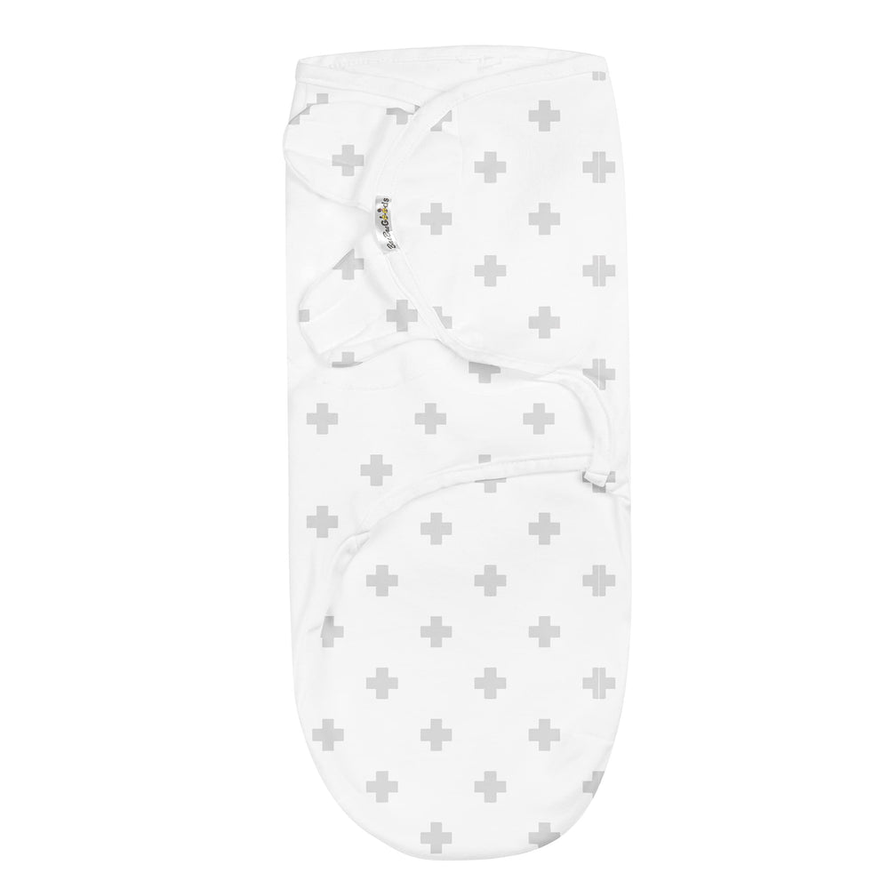 Infant wrapped snugly with adjustable Baebae Goods swaddle, safe and secure.
