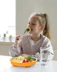 Bakpoco green suction plate with lid for travel and storage.