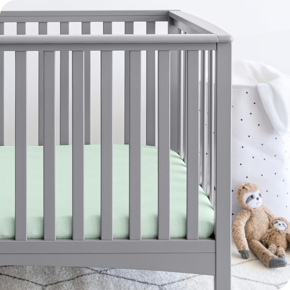 Bare Home spring mint crib sheets demonstrating breathable microfiber texture in a nursery.
