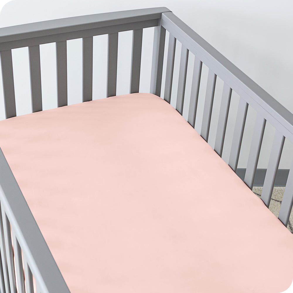 Bare Home crib sheet elastic edge close-up for a secure fit on a standard mattress