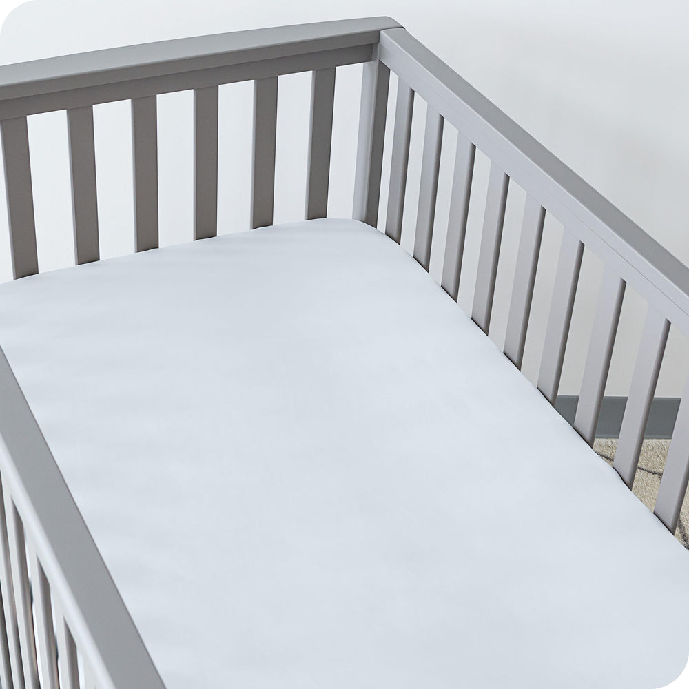 Bare Home fitted bottom sheet on standard crib mattress for secure fit
