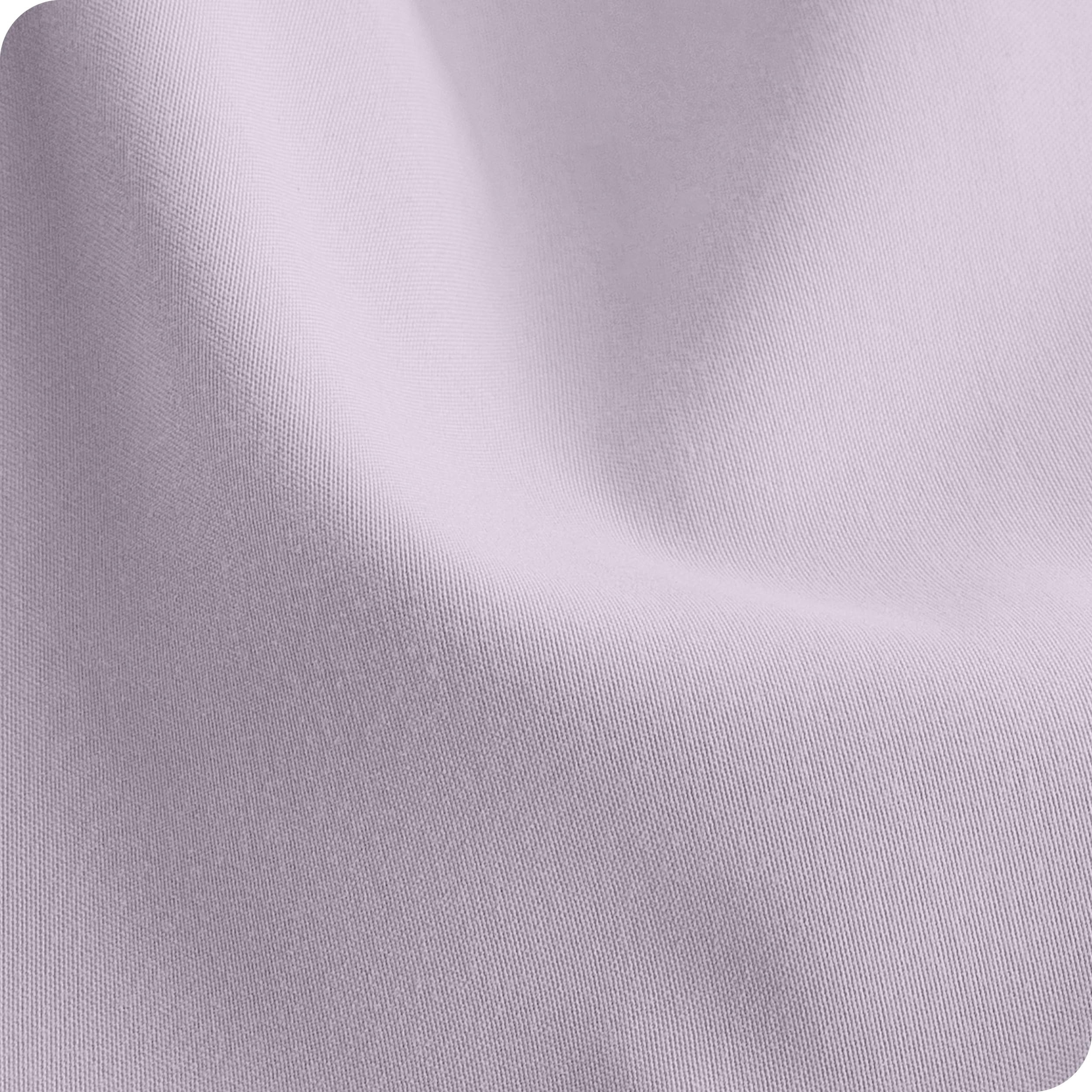 Bare Home sheets placed on a standard crib mattress to illustrate fit