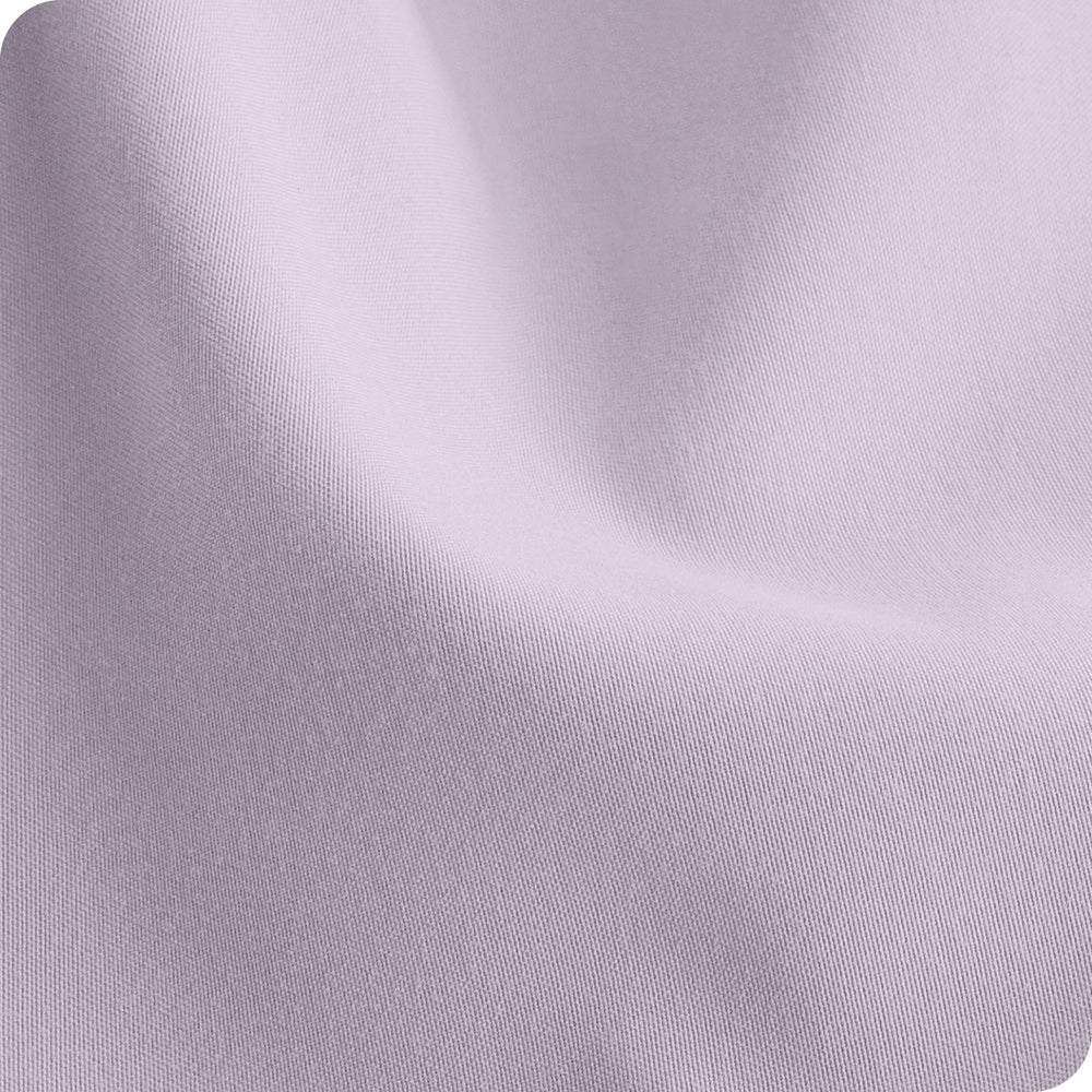 Bare Home sheets placed on a standard crib mattress to illustrate fit