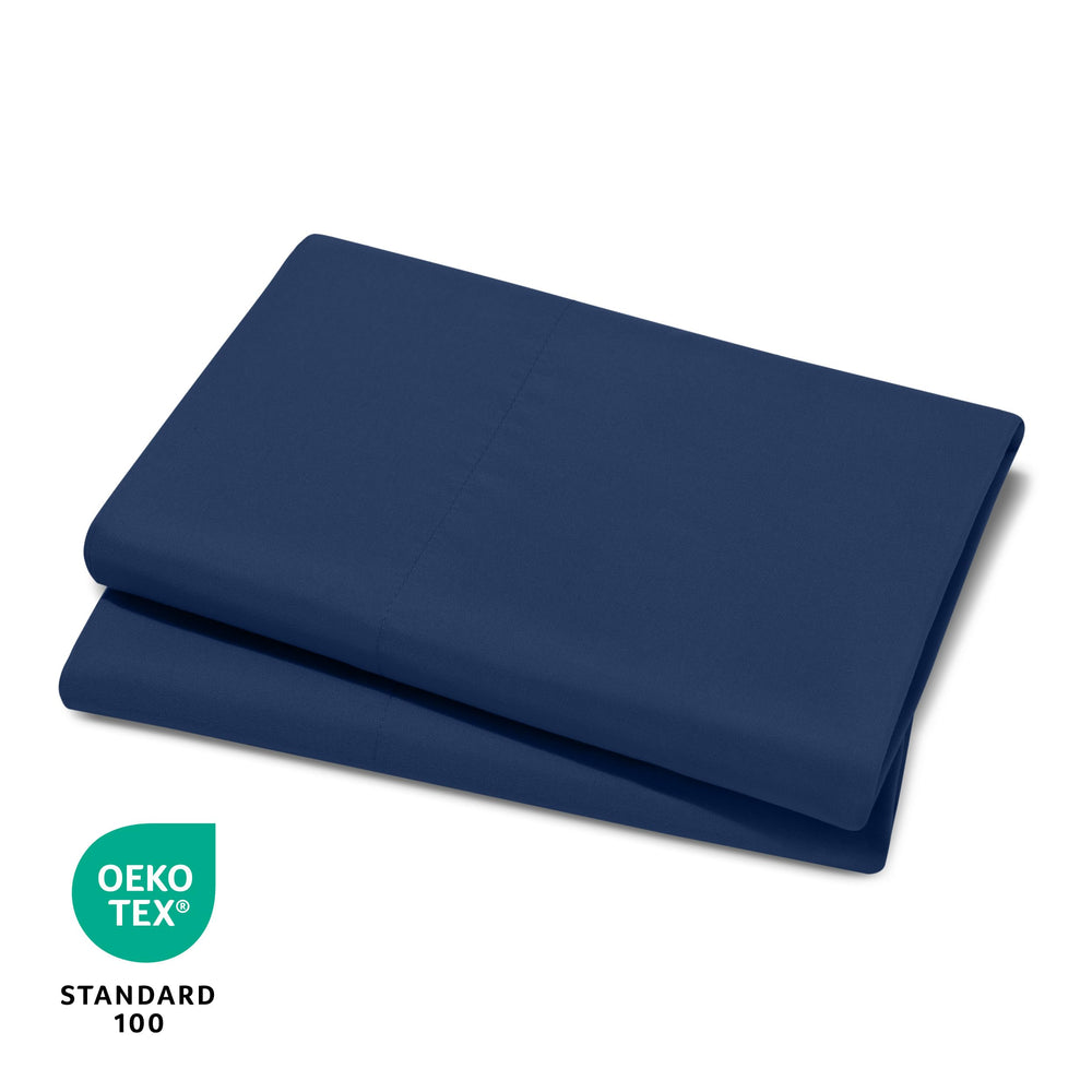 Bare Home dark blue pillowcase on bed with neat stack for kids