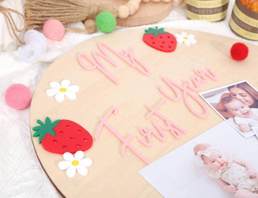 BASCT baby milestone display with strawberry accents for nursery charm.