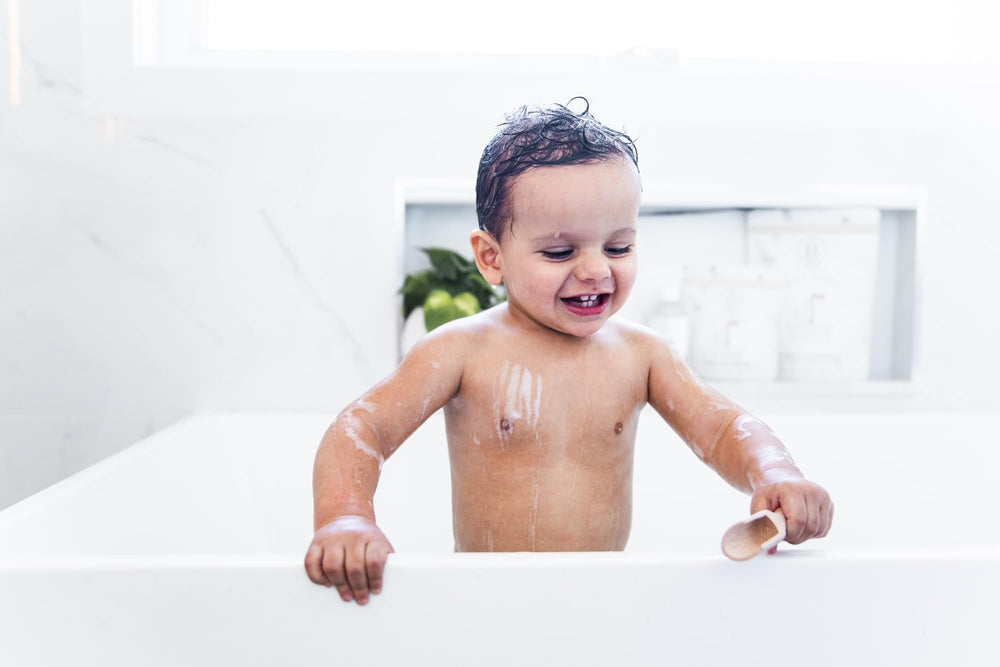 Pouring Little Charlie Bath Soak into warm bath for delicate skin