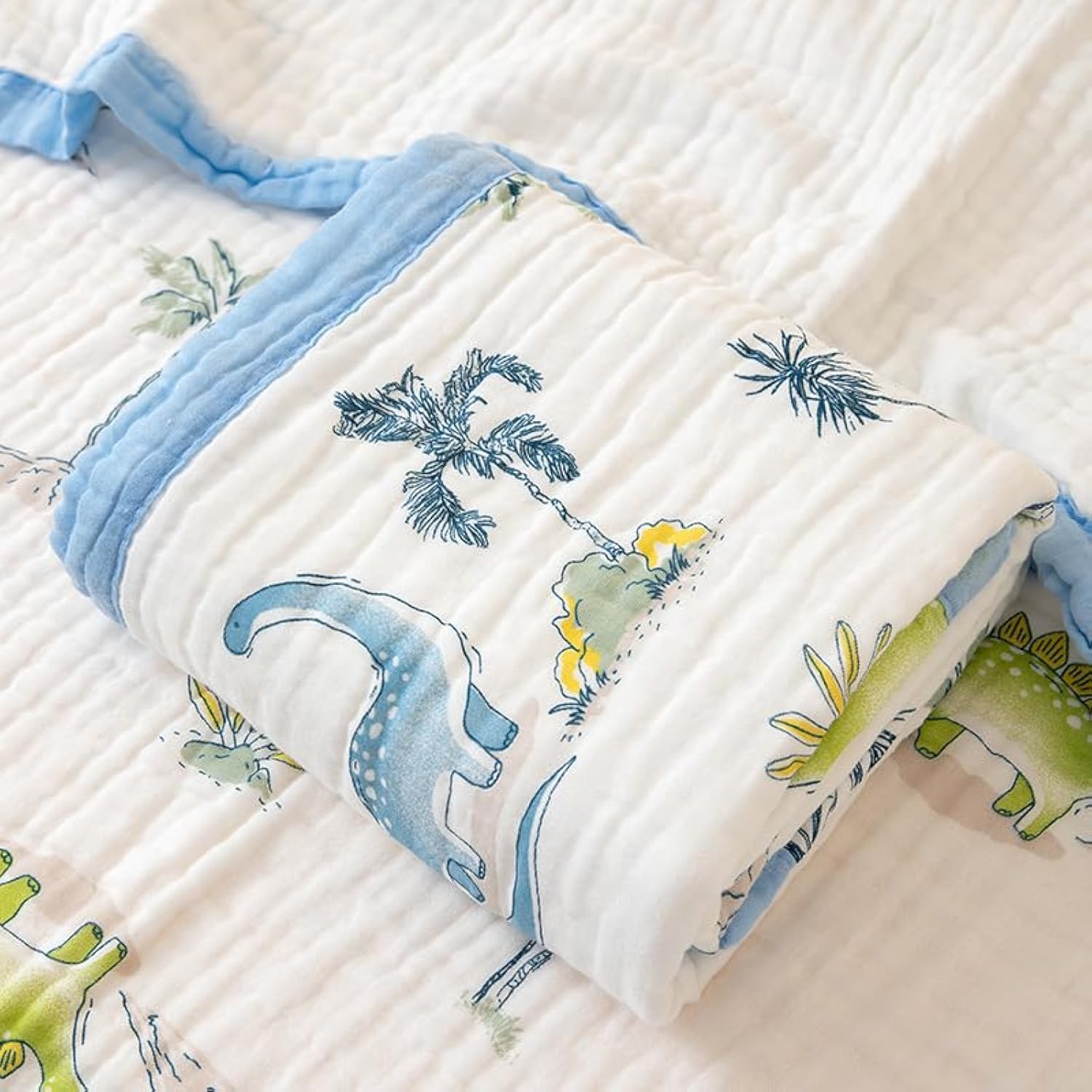 Battilo Pty dinosaur-pattern muslin blanket provides soft, breathable comfort for calm naps.