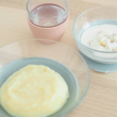 BEABA cup with protective sleeve guards hands and prevents slips during feeding.