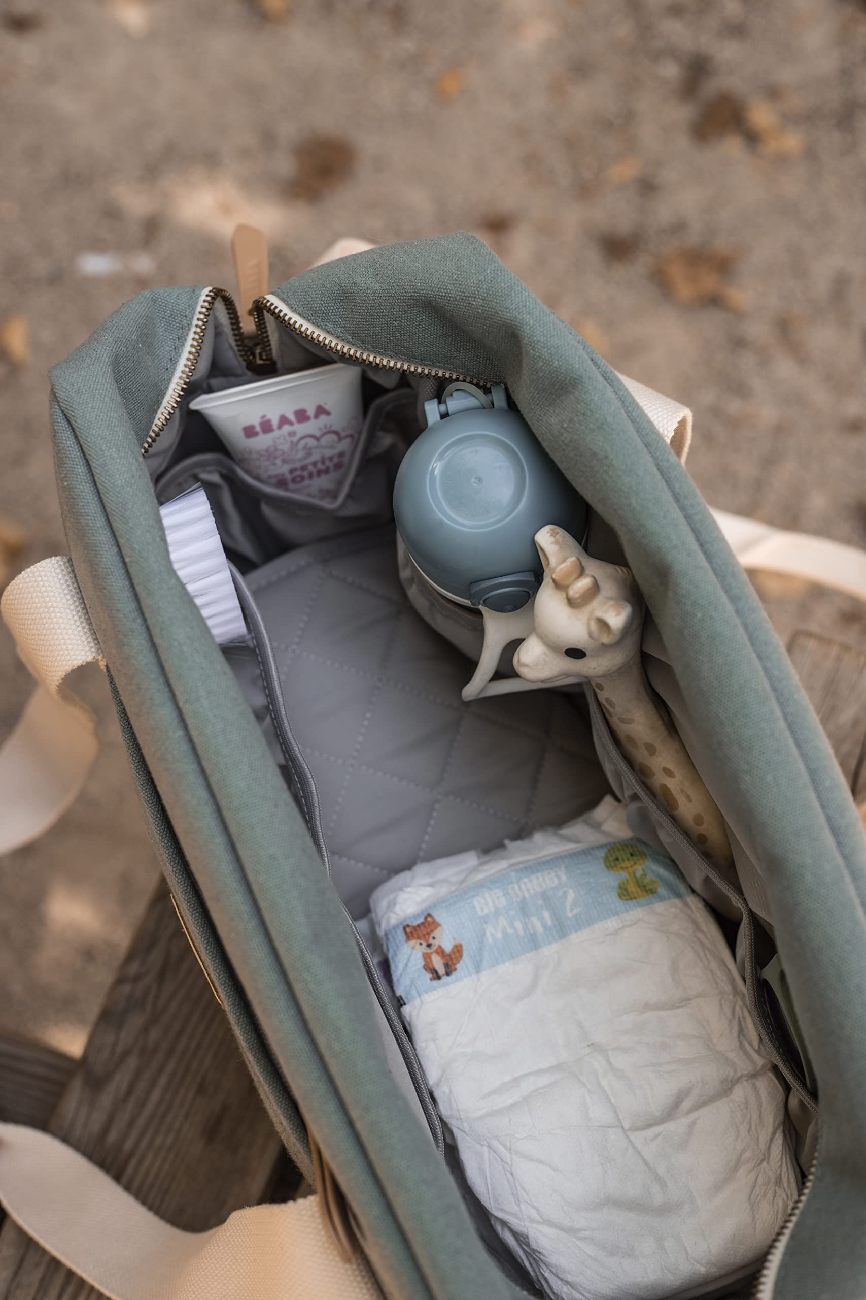 BEABA Paris Diaper Bag insulated pocket keeps bottles warm or cool.