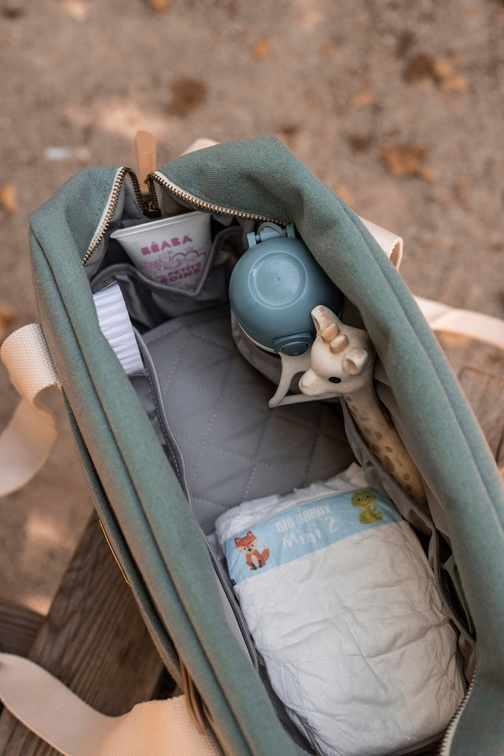 BEABA Paris Diaper Bag insulated pocket keeps bottles warm or cool.