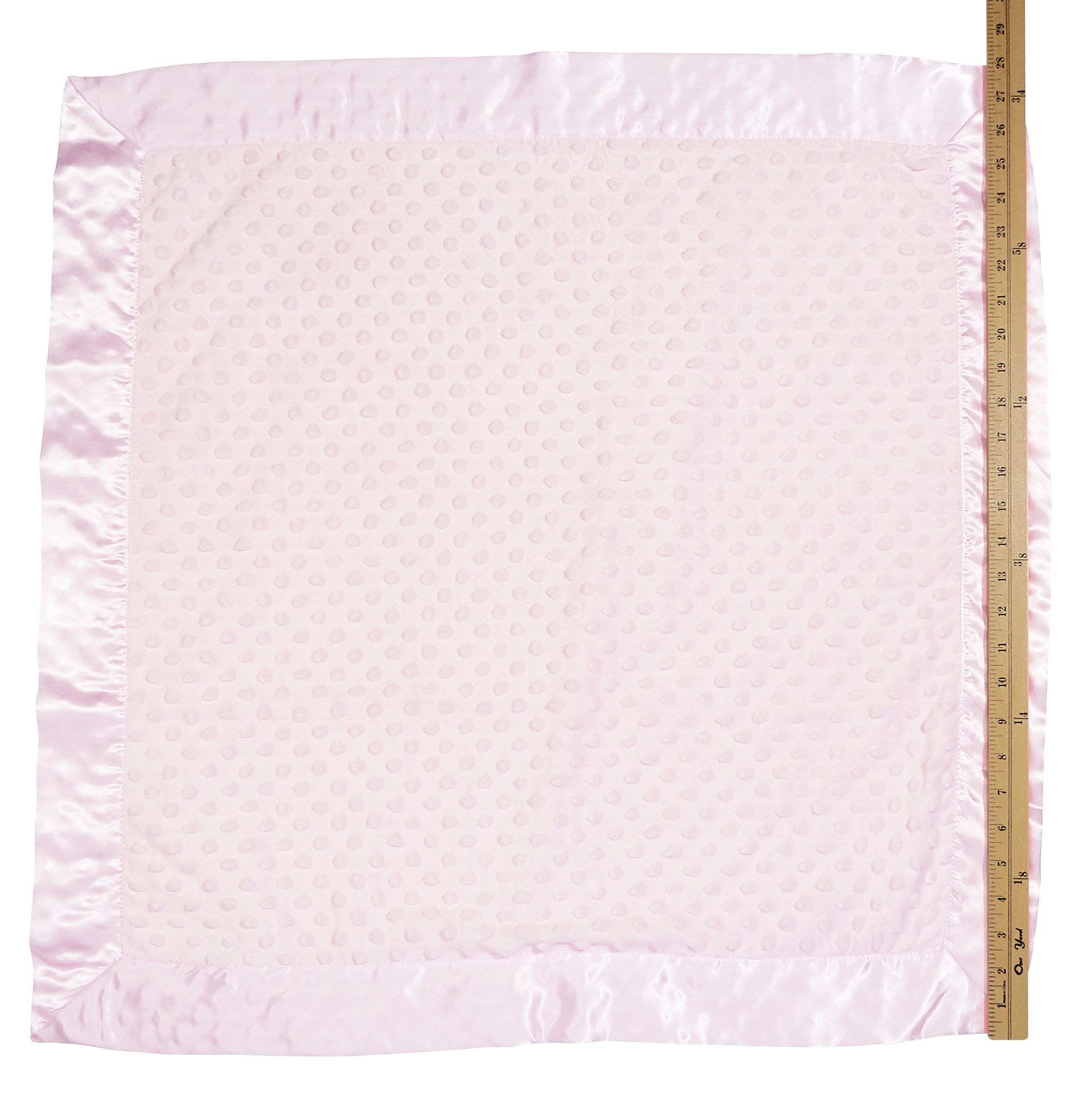 Bearington Collection pink satin trim blanket on crib showcases cozy styling for nurseries.