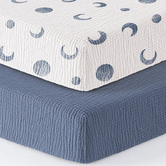 Bearmoss muslin mini crib sheet with blue crescent on Pack-N-Play mattress for cozy naps