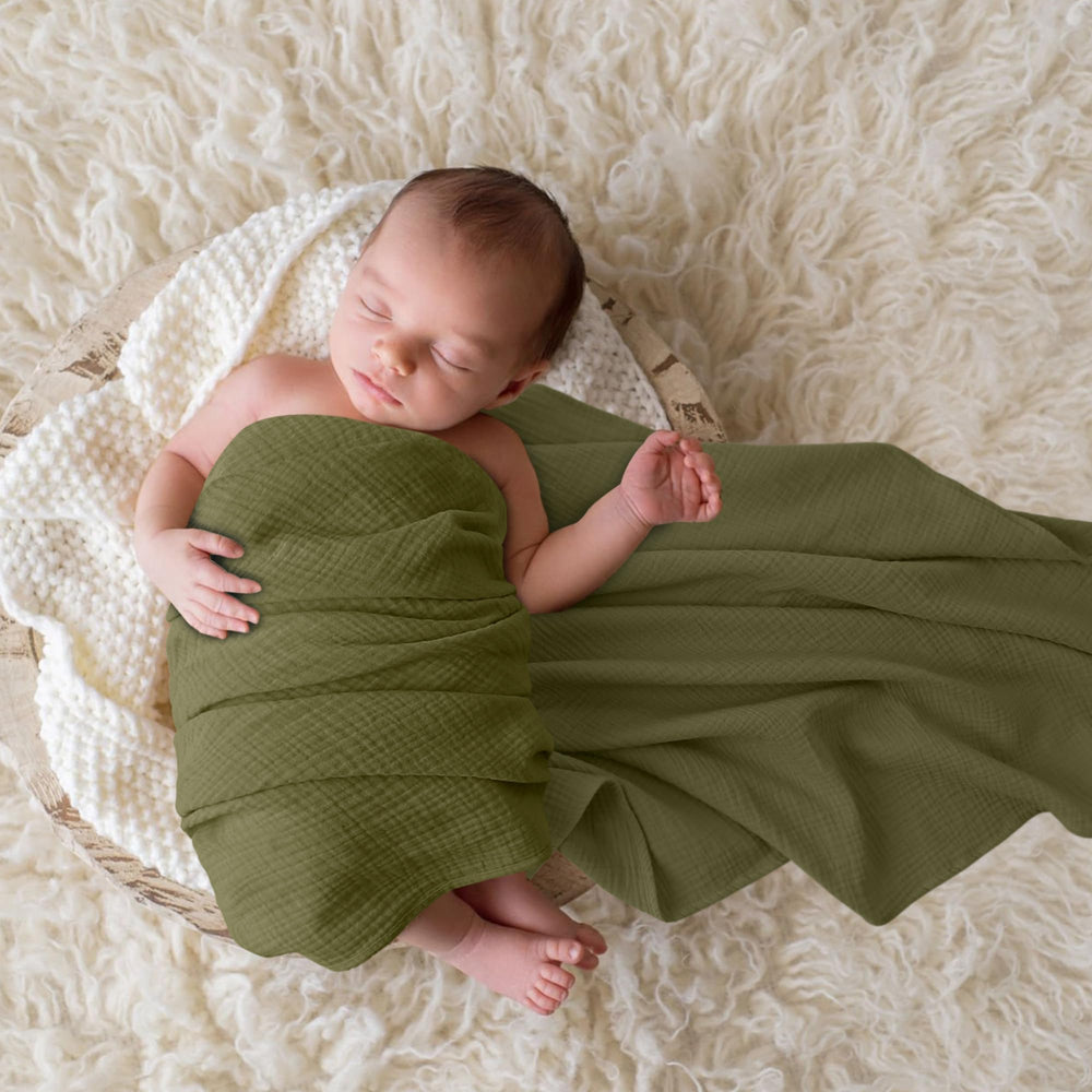 Bearmoss muslin swaddle blanket grey-green baby wrapped securely for comfort.