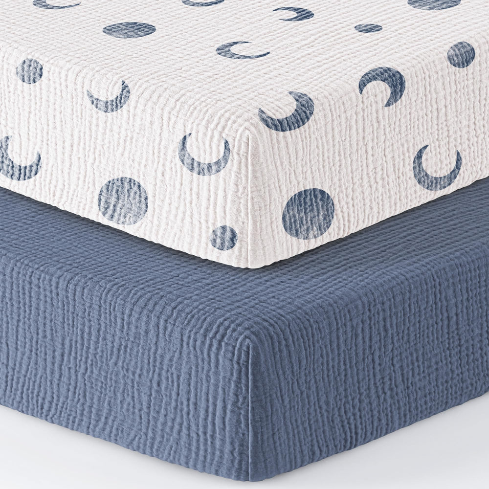 Two-pack Bearmoss blue crescent crib sheets in packaging.