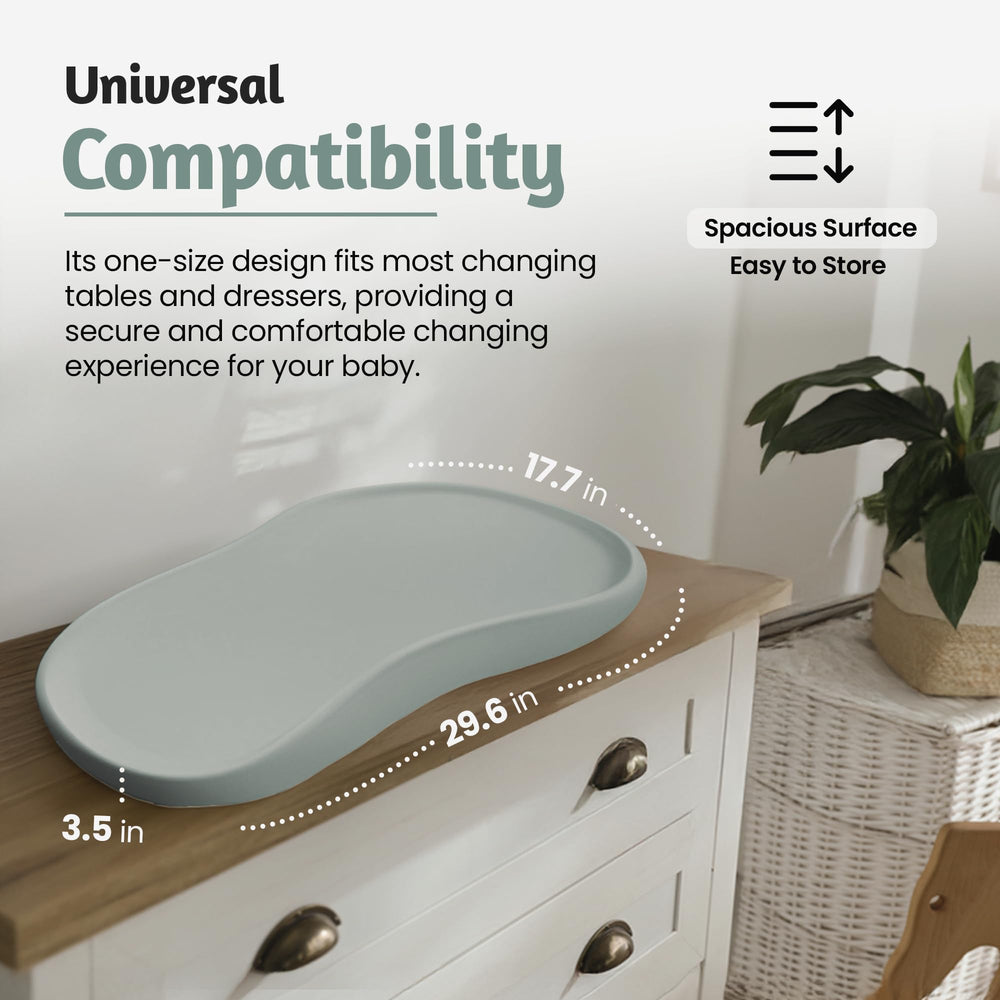 Universal fit changing pad in teal, compatible with most tables and dressers.