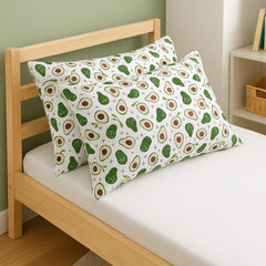 Bebek Ozel avocado-print pillowcase adds playful nursery decor to a toddler bed.