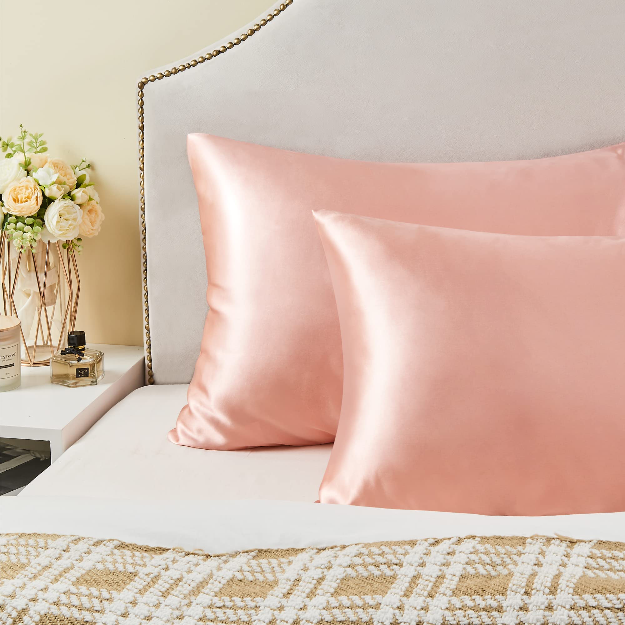 BEDELITE toddler-size coral satin pillowcase on a bed