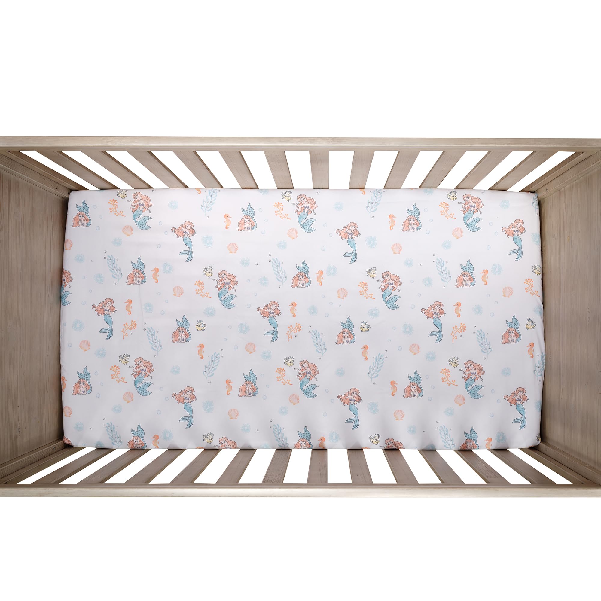 Bedtime Originals Ariel seashells bubbles print brightens the nursery ambiance.