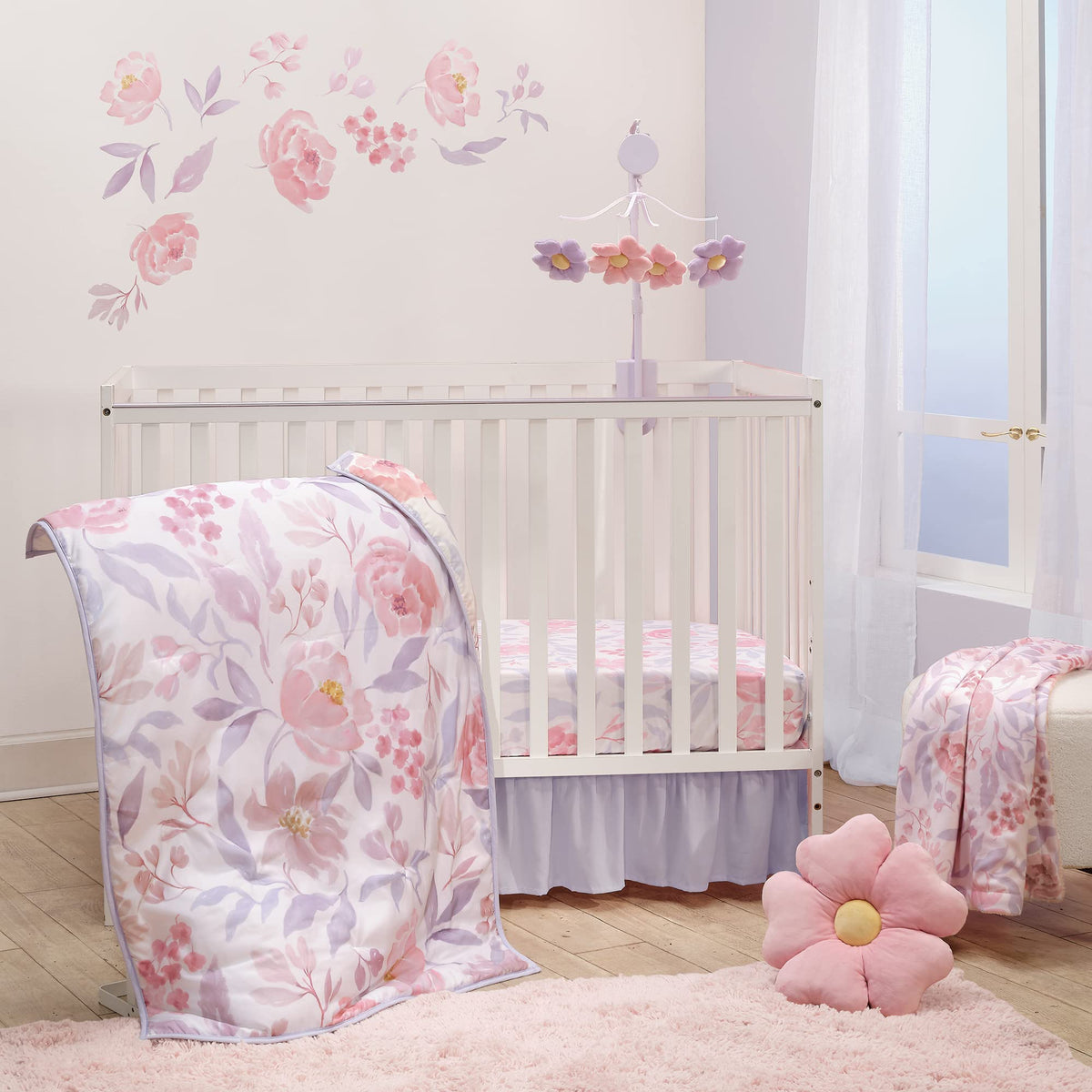 Bedtime Originals lavender floral quilt showing watercolor roses for a cozy nursery accent.