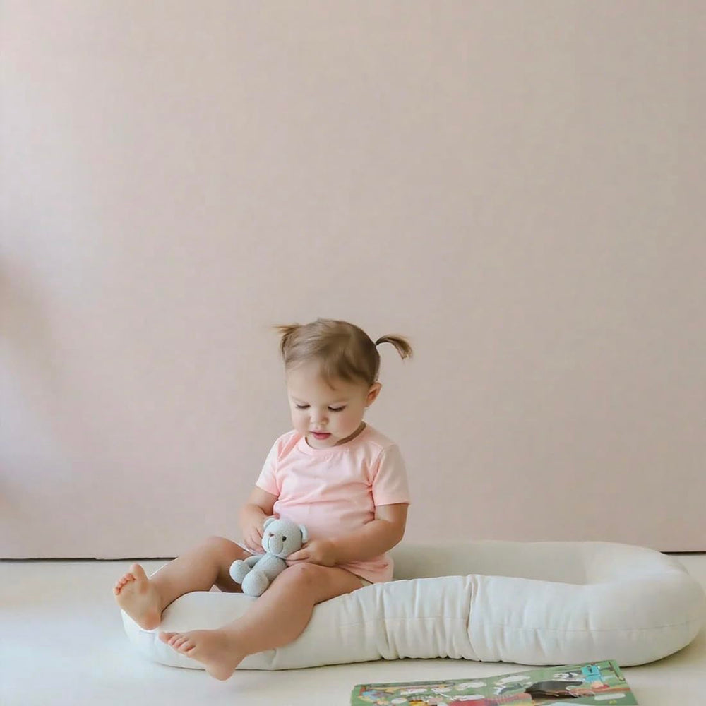Beisurznga baby lounger portable playtime nest in living room.