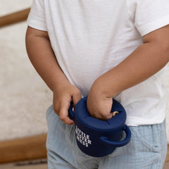 Bella Tunno snack cup shows soft silicone flaps for easy access