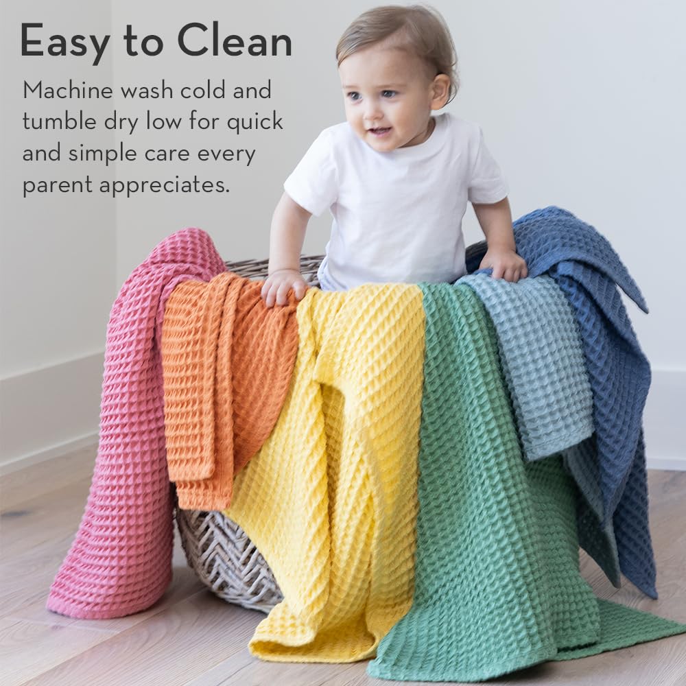 Tummy time exploration with Bella Tunno waffle blanket for comfort.