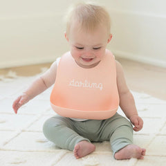 Bella Tunno Wonder Bib with two-snap neck grows with baby from 4 to 12 months.