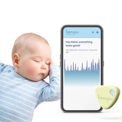 Bempu Bellybutton movement monitor clipped on baby's clothing for secure night monitoring.
