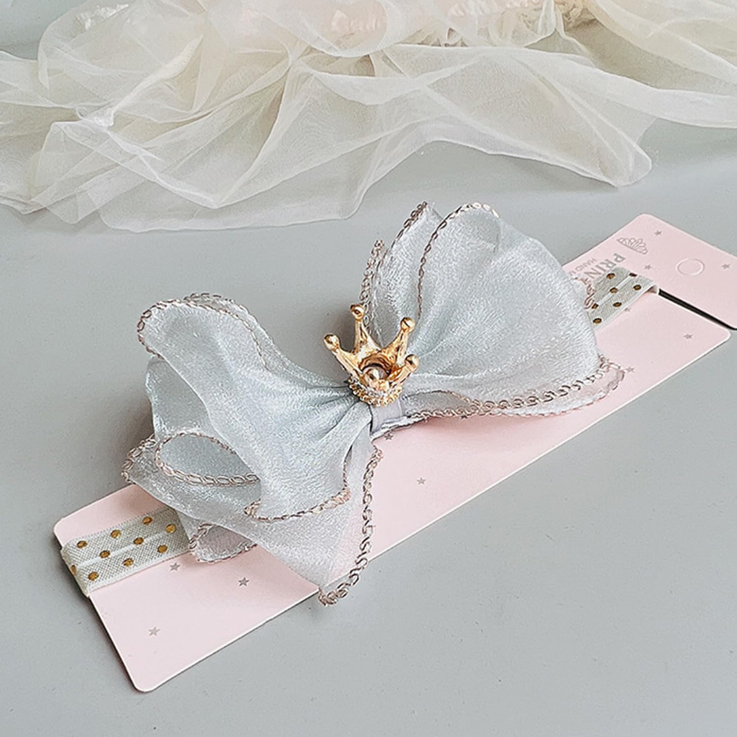 Bethynas gray baby hair accessory with bowknot and crown detail