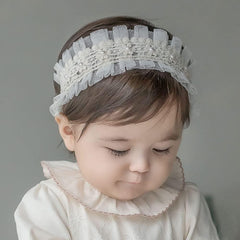 Elastic Bethynas headband for baby girls with gentle stretch and floral motif