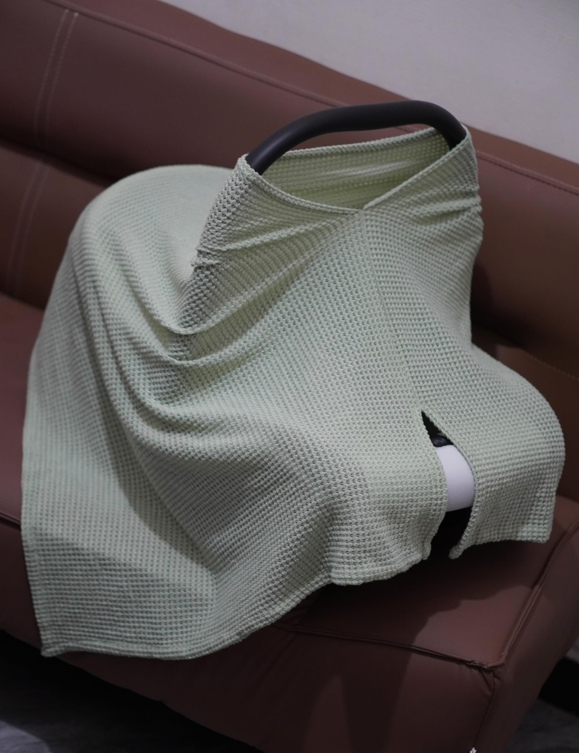 BEWDIO Green wearable shawl draped over shoulders during feeding