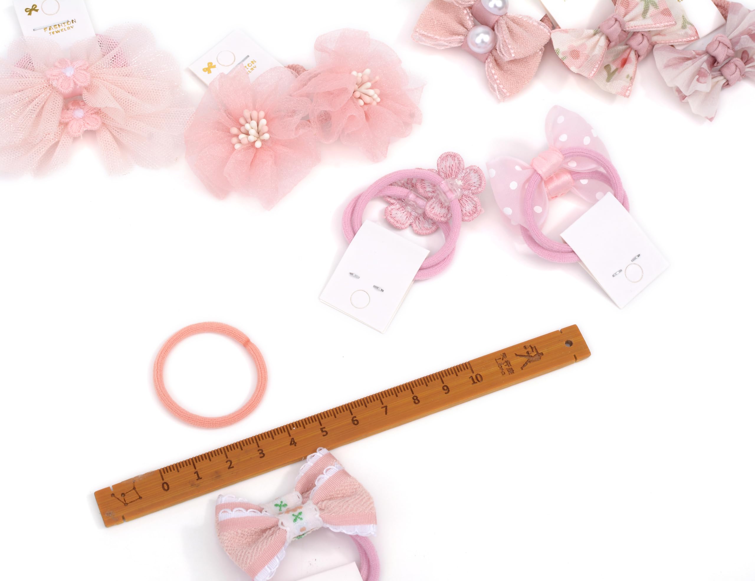 Close-up of BIANHUAN bows on tiny elastic hair ties for kids