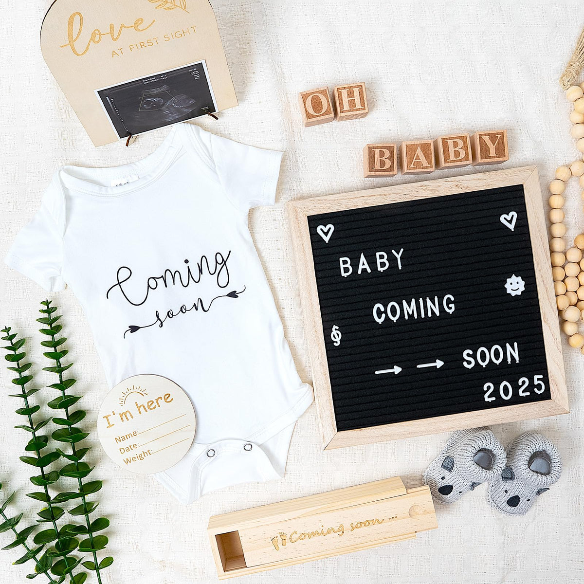 BIBIBLISSBABY pregnancy onesie on display for a cute coming soon reveal