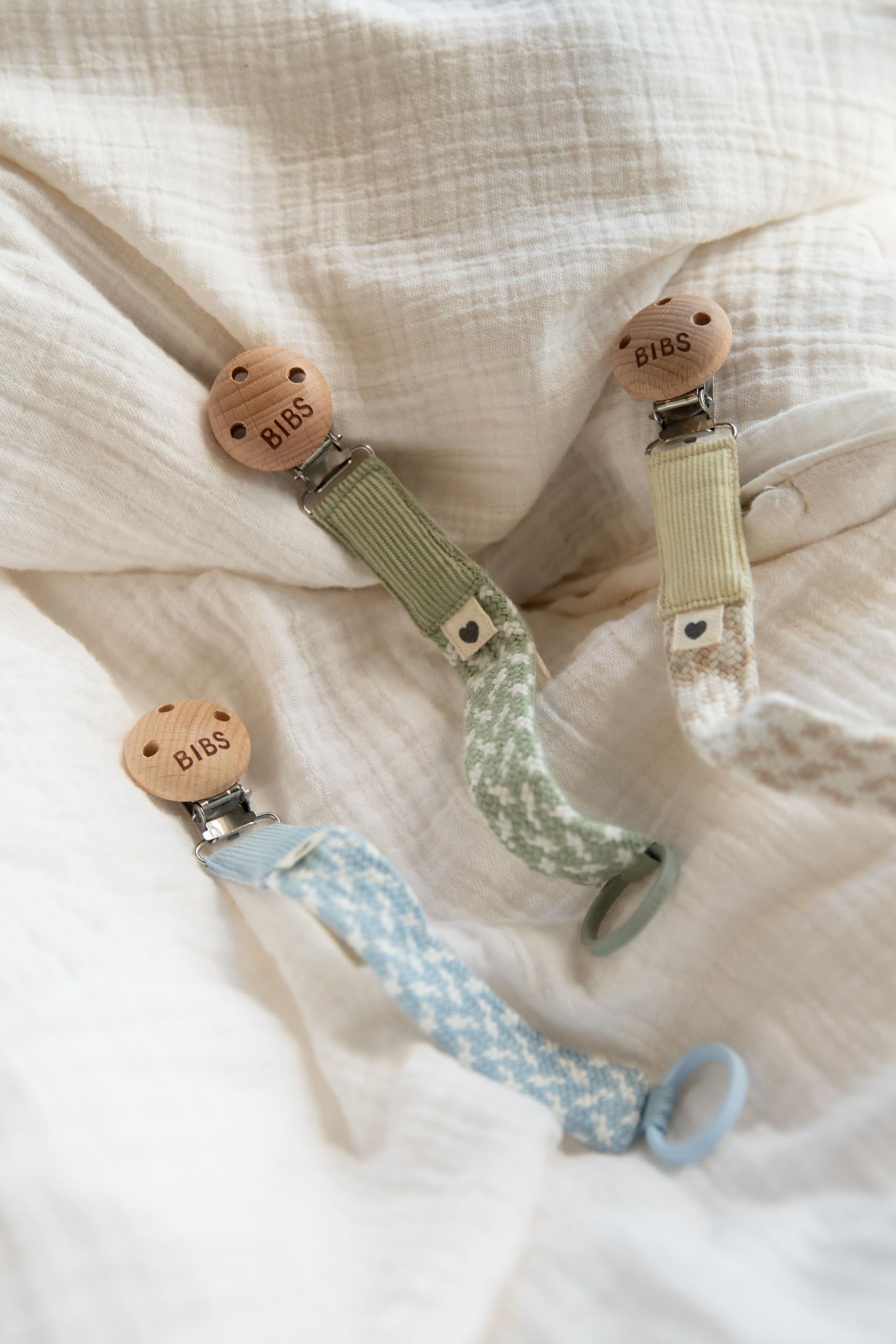 Danish-designed Bibs Paci Braid chain in soft pale butter.