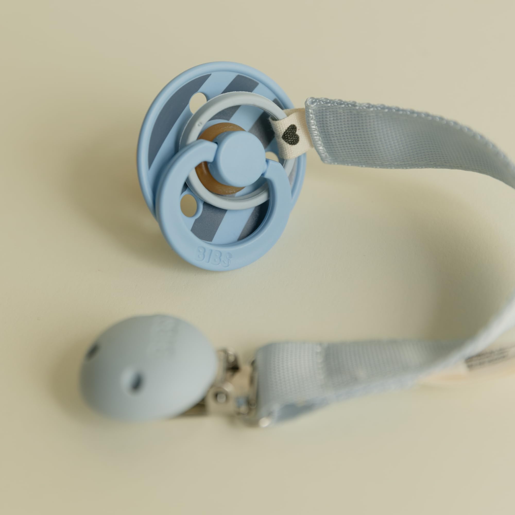 BIBS pacifier clip ribbon blush detail focusing on easy maintenance