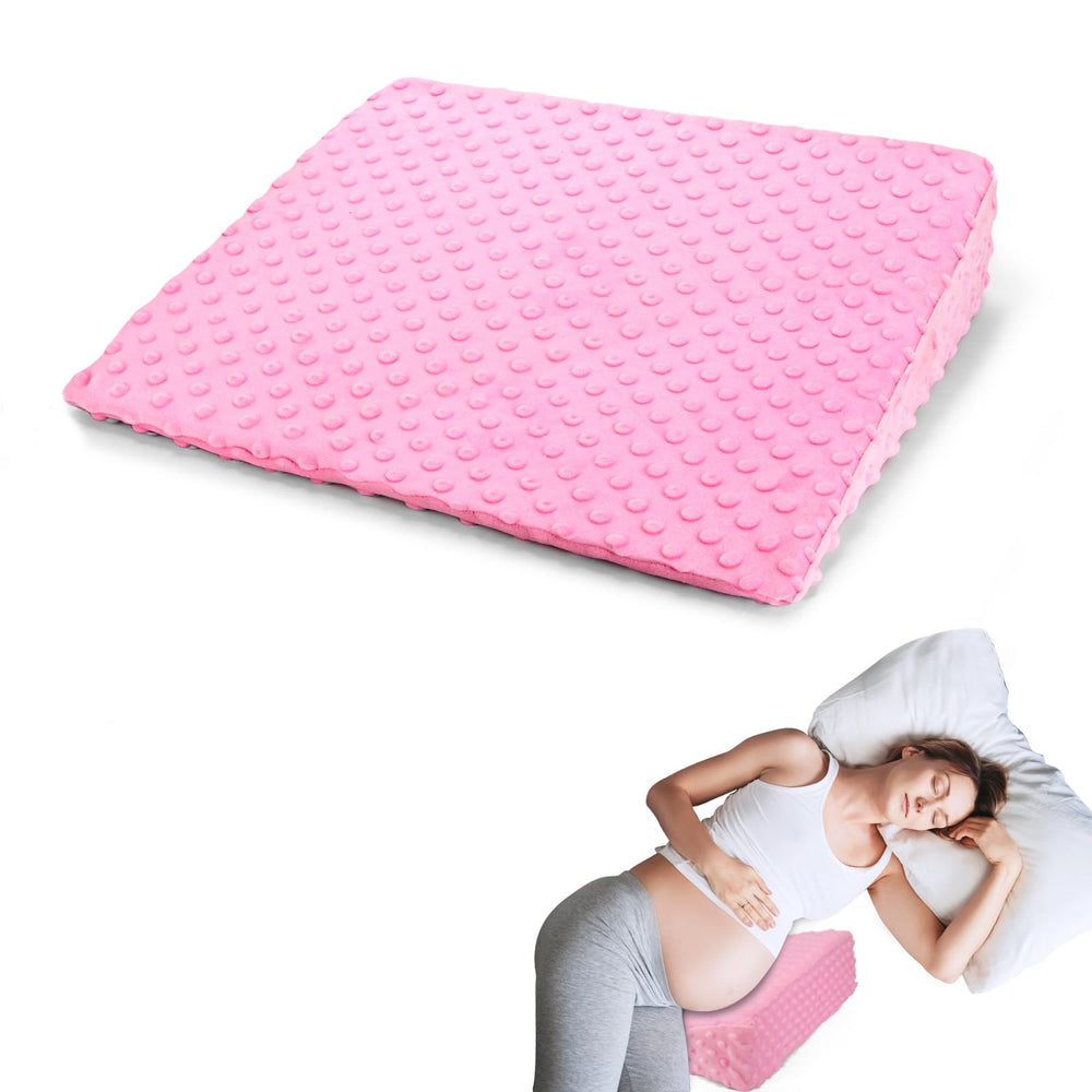 BiKontrun pregnancy wedge pillow with pink cover providing belly support for side sleeping.