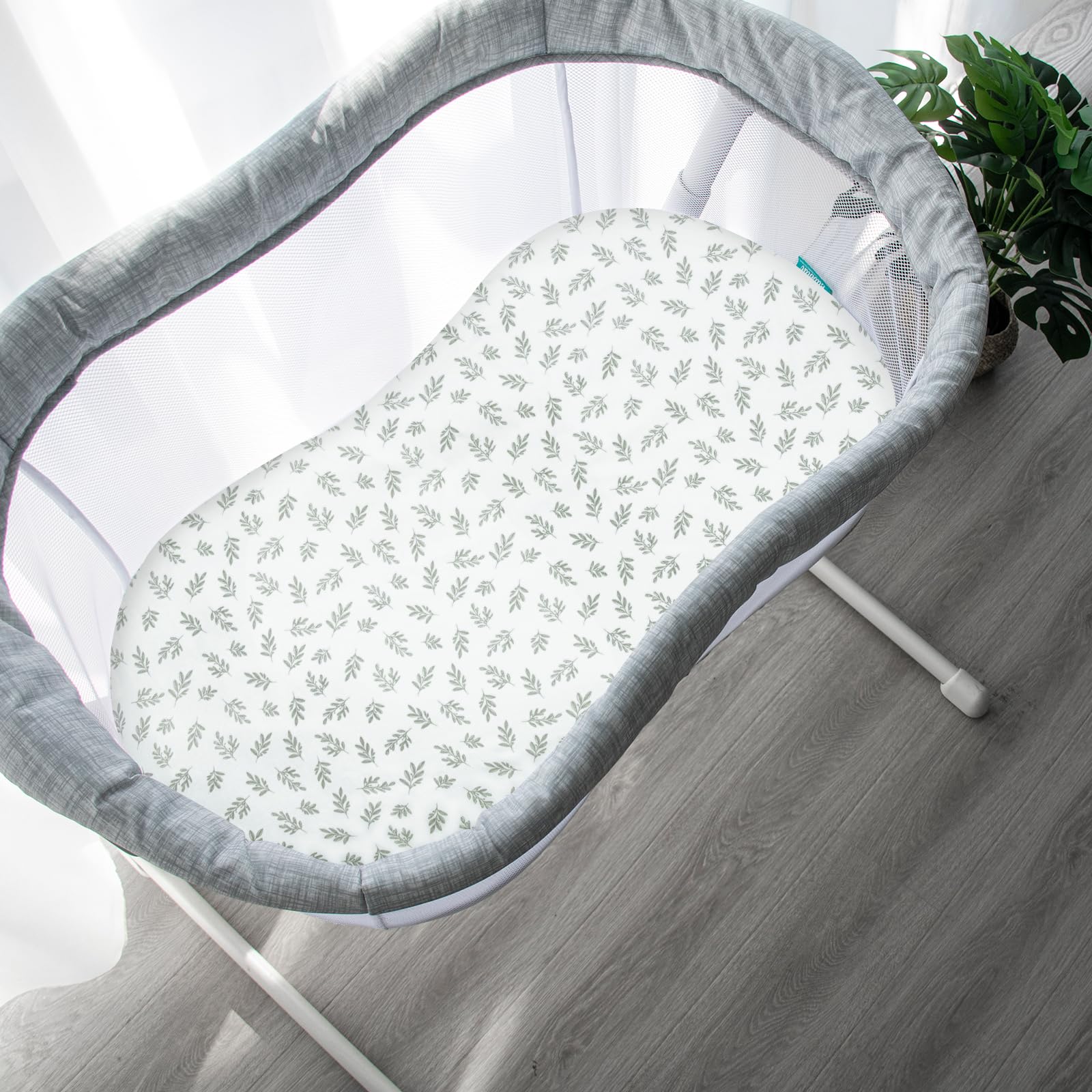Four-pack Biloban sheets with neutral prints for versatile nursery styling.