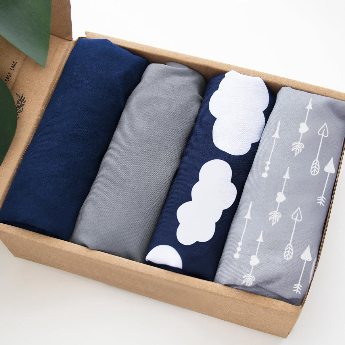 Biloban bassinet sheets with fully encased elastic edge for a secure fit.