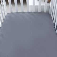 Biloban crib sheets show a snug elastic edge for secure nighttime fit.