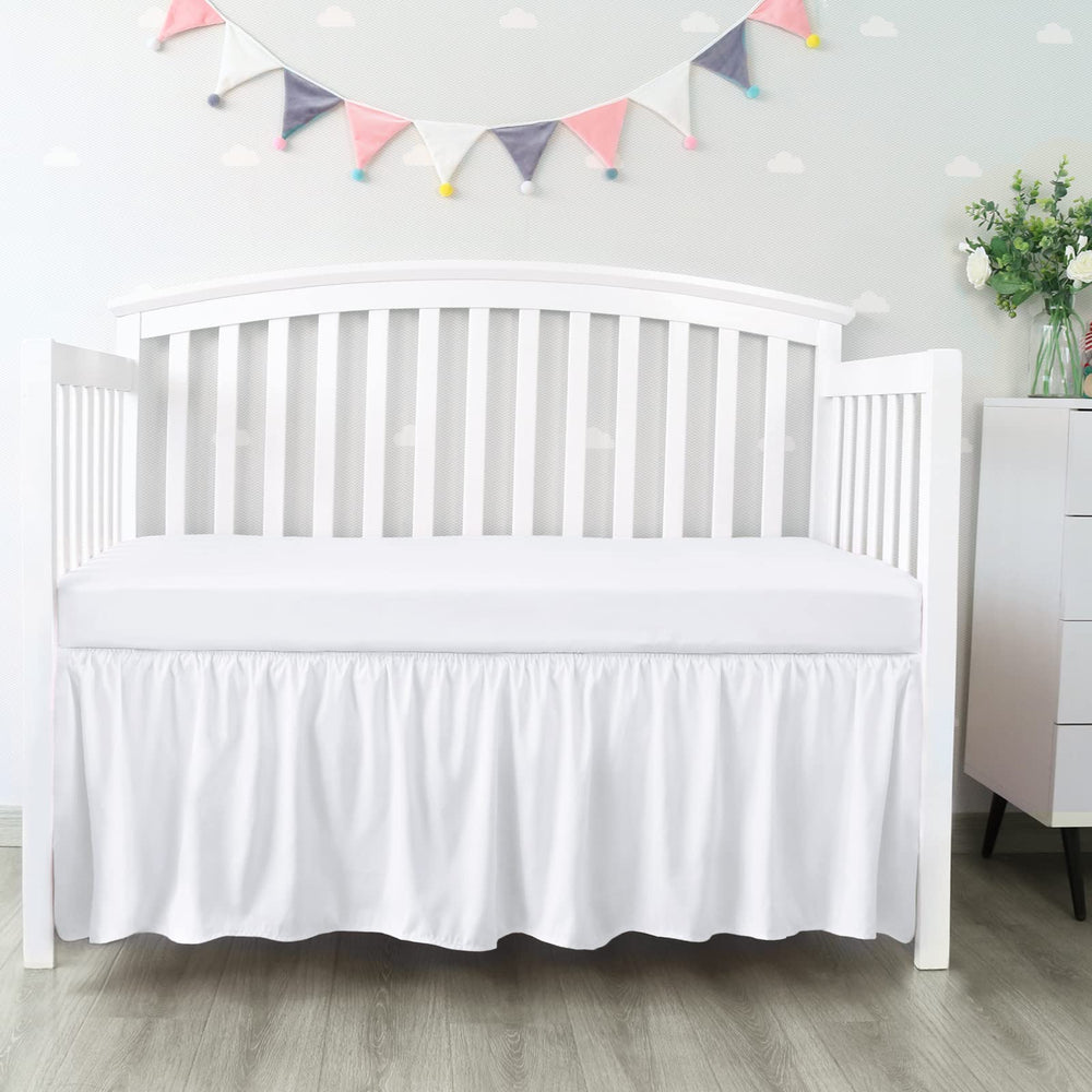 Biloban crib skirt with 14-inch drop conceals under-crib storage.