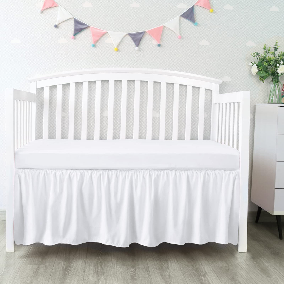Biloban crib skirt with 14-inch drop conceals under-crib storage.