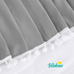 Biloban dust ruffle detail around crib for a polished look.